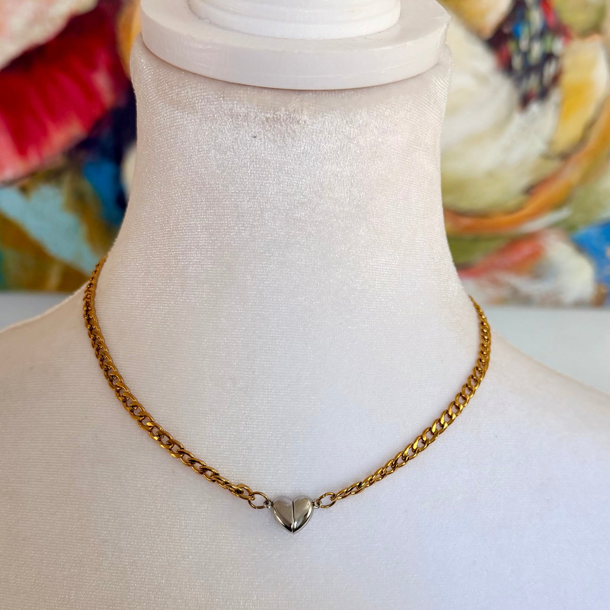 Gold chain necklace on a mannequin with a colorful background