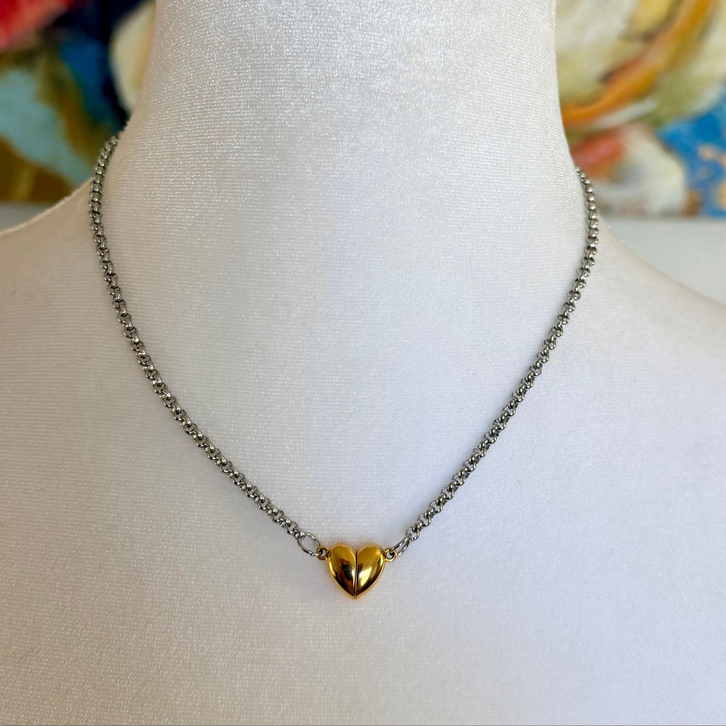 Necklace with a gold heart pendant on a mannequin bust