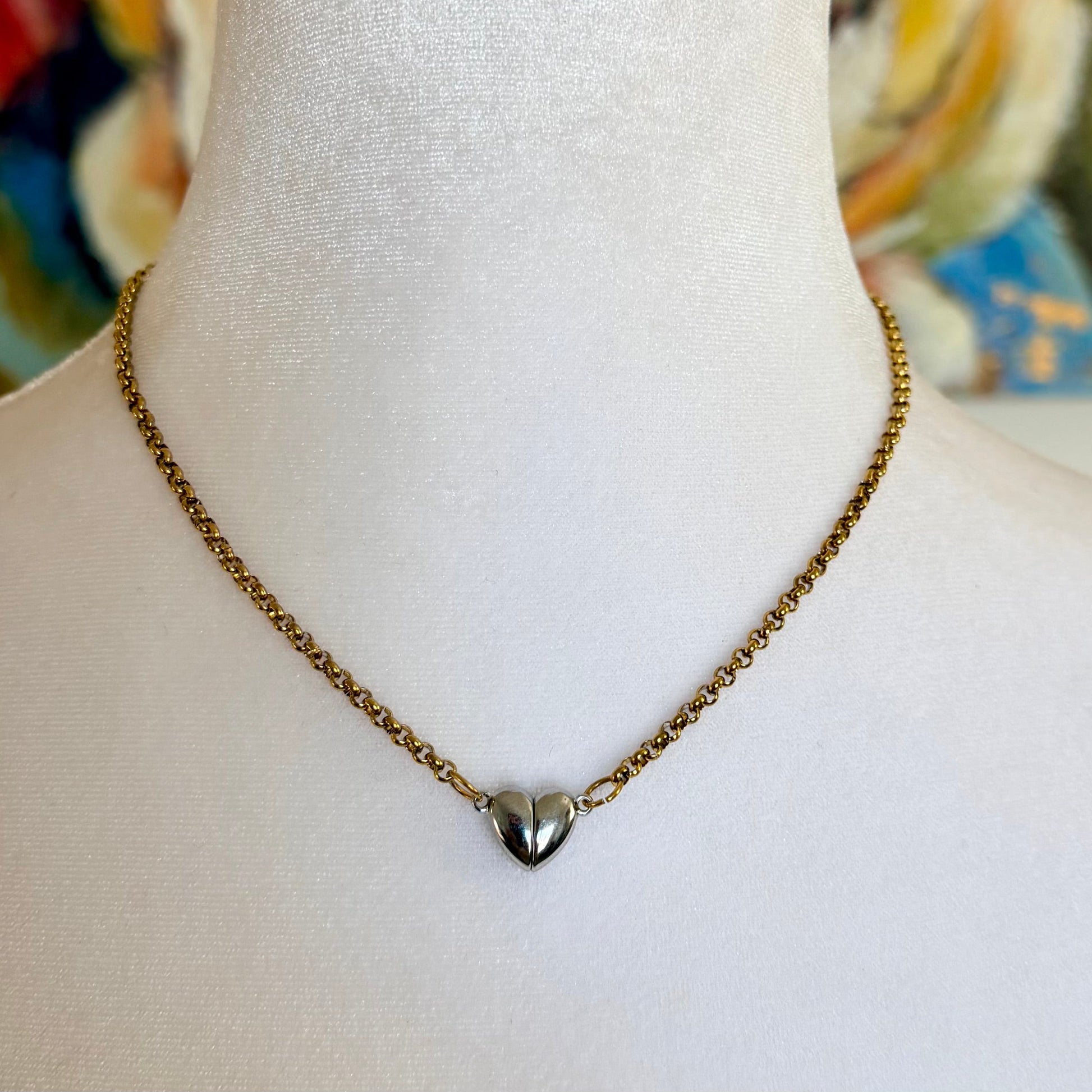 Necklace with a heart pendant on a mannequin against a colorful background