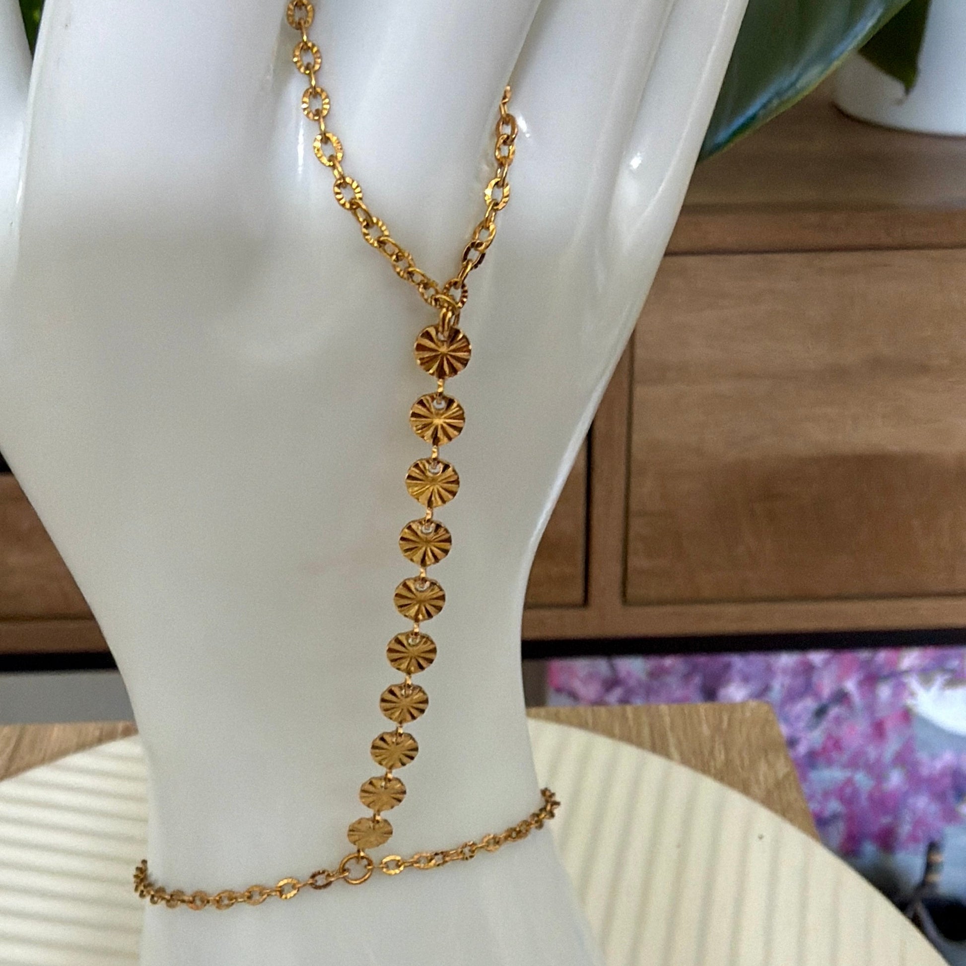 gold stainless steel hand chain on white hand mannequin