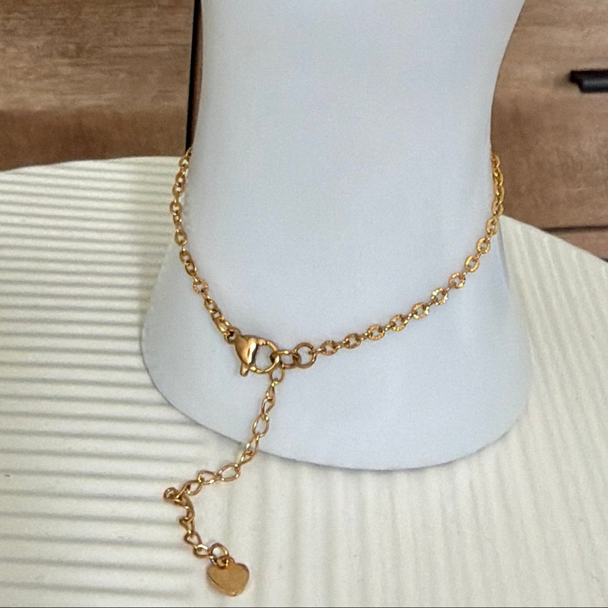 gold stainless steel hand chain on white hand mannequin