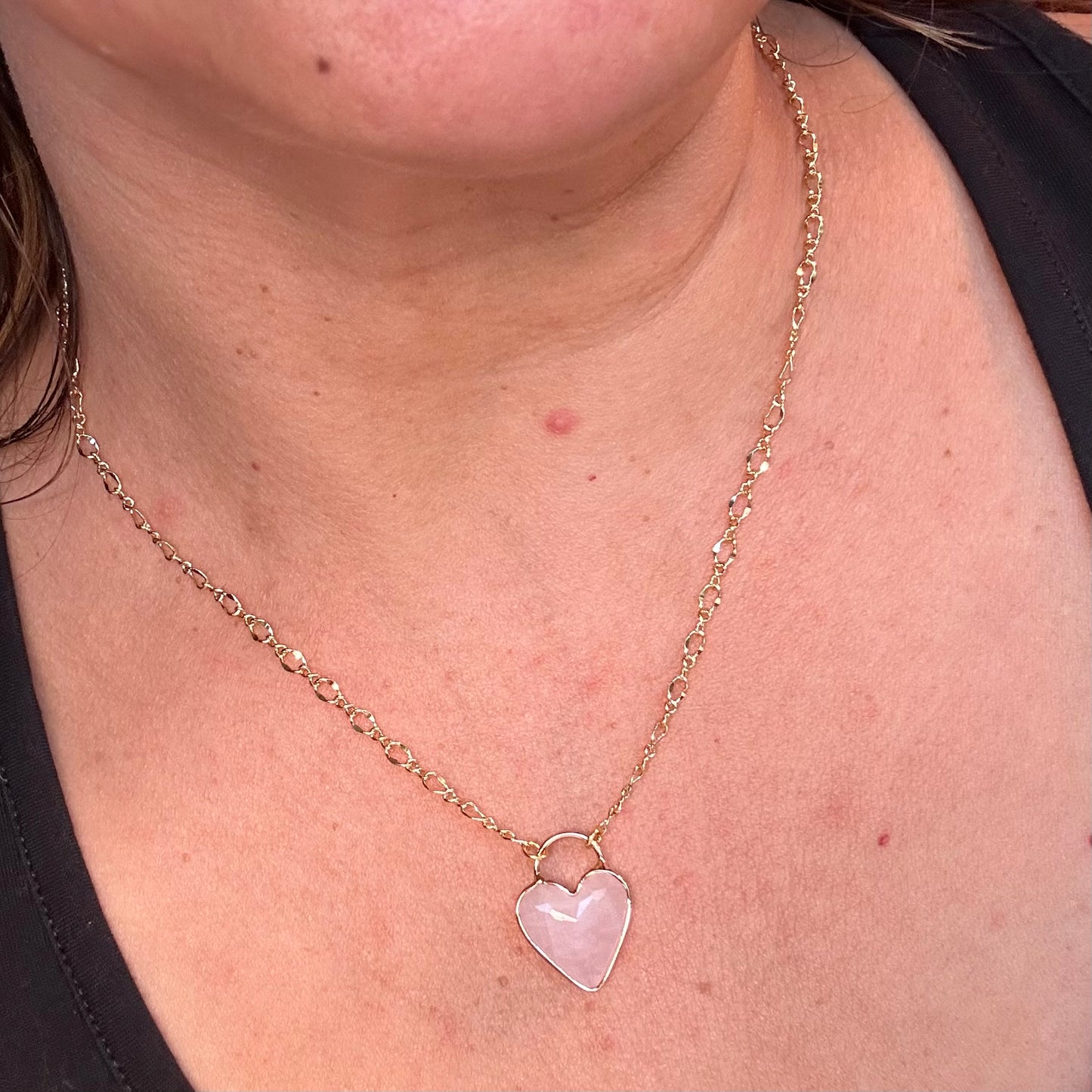 18" gold filled chain with heart shaped rose quartz pendant worn around the neck